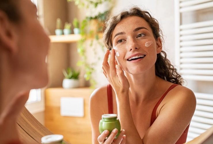 Applying moisturizer to face