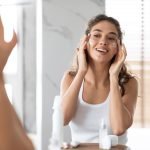 Applying facial moisturizer