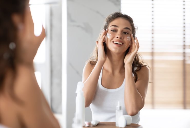 Applying facial moisturizer